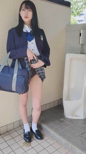 A student with long black hair after school in the public toilet behind the school